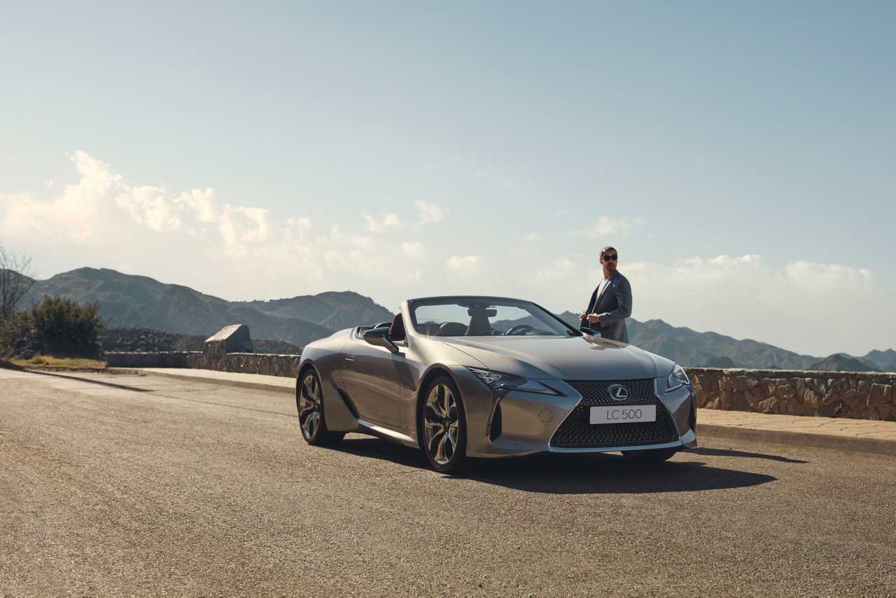 A man standing next to a Lexus LC Convertible