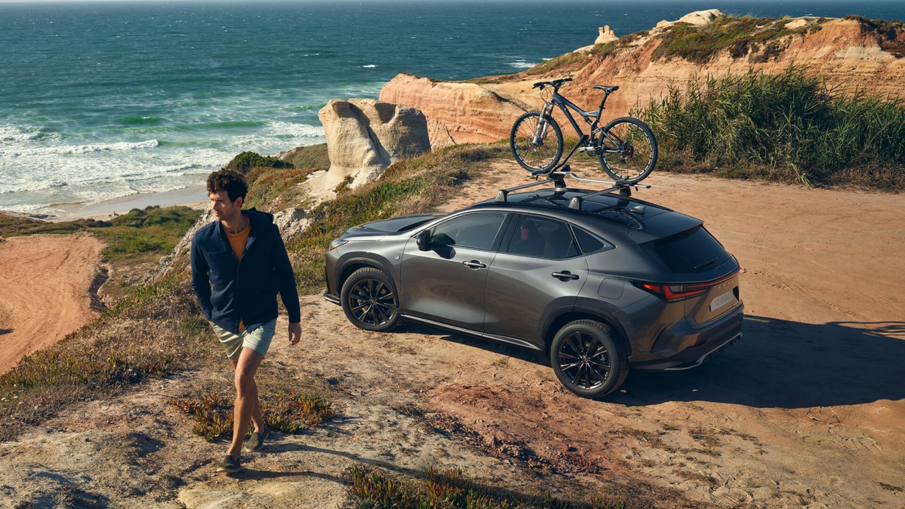 A man walking away from a Lexus NX at the coastal location