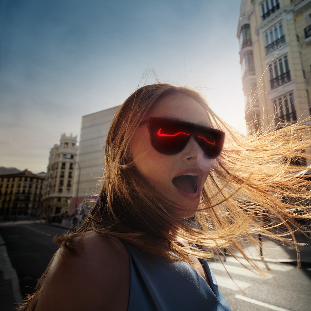 A woman with a Lexus reflecting in her sunglasses